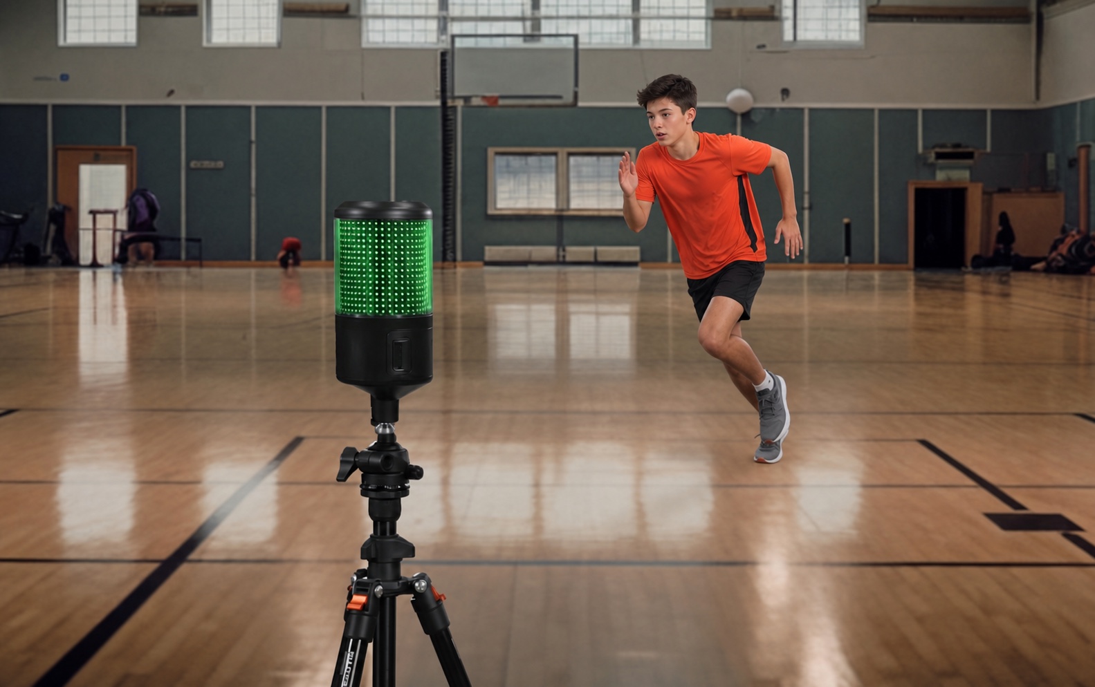 A youth athlete accelerating past an electronic timing gate on a tripod